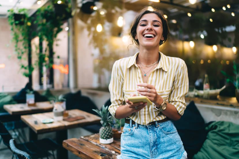 Woman smiling using smartphone